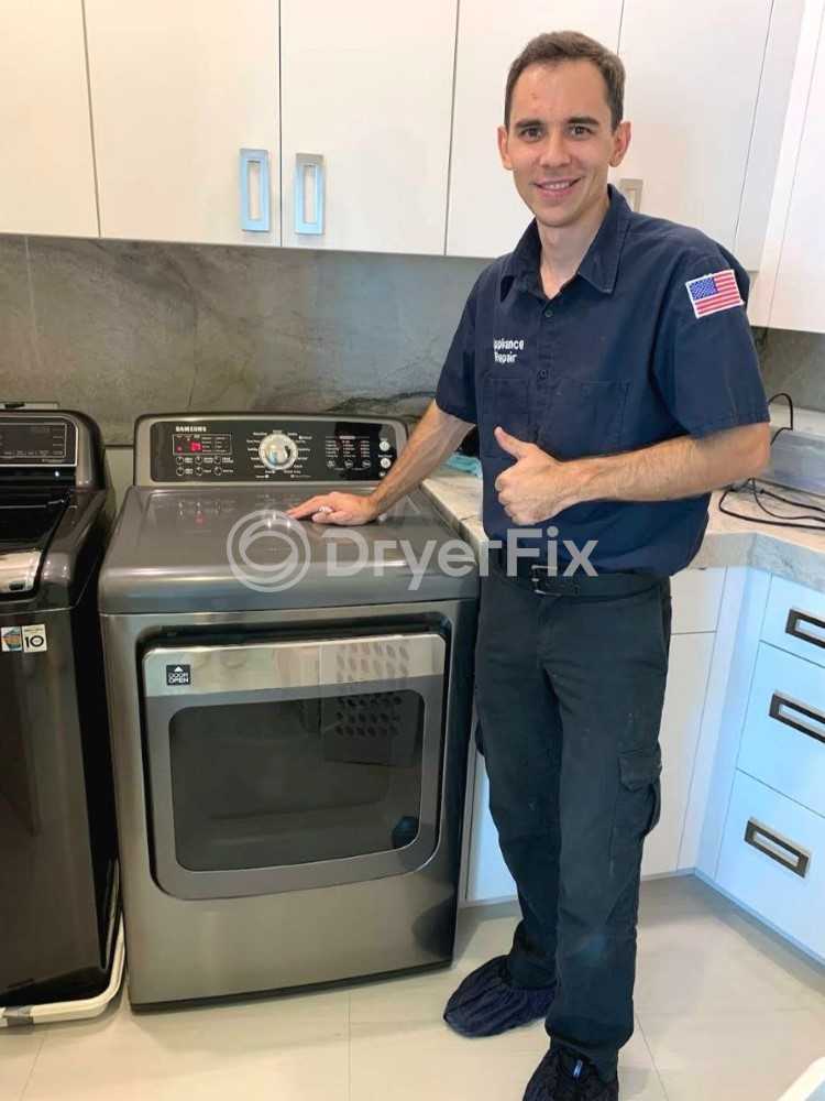 Smiling technician in uniform, ready to repair dryer