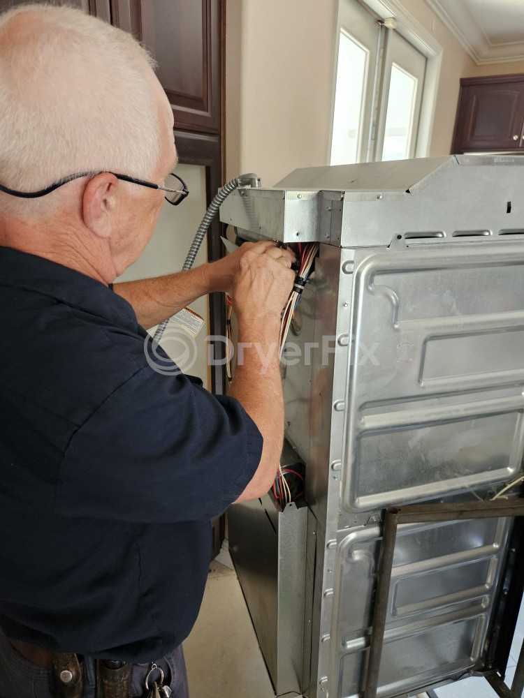 DryerFix technician repairing a dryer