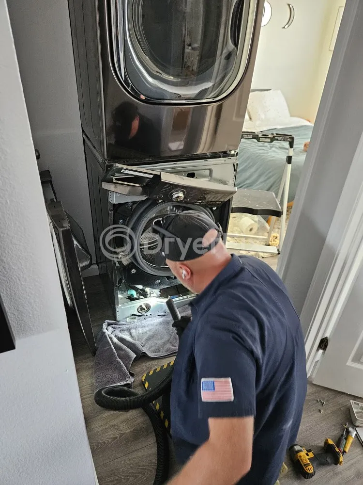 Technician fixing broken dryer